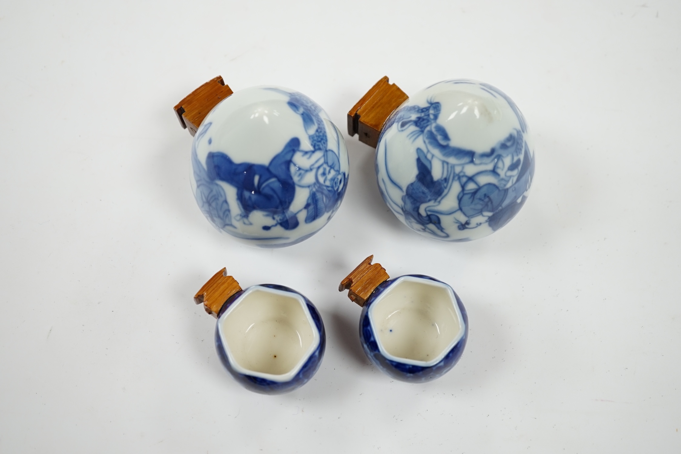 Four Chinese blue and white porcelain bird feeders, largest 7cm high. Condition - good, some glue residue